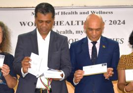 The Ministers of Health and Environment (centre) present the commemorative WHO stamp in presence of the WR, Dr Anne Ancia. 