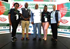 WHO staff with Minister of Health, Dr Aaron Motsoaledi (middle) during the Closing 1.1 Million HIV Treatment Gap Campaign at Chris Hani Baragwanath Hospital in Johannesburg