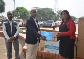  Dr. Cuallau Jabbeh Howe, the Assistant Minister of Health, receiving the donation from WHO OIC, Dr Abdullahi Sule