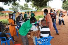 A health worker  administers a dose of COVID-19 vaccine