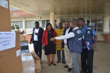  Dr. Cuallau Jabbeh Howe, the Assistant Minister of Health, receiving the donation from WHO OIC, Dr Abdullahi Sule